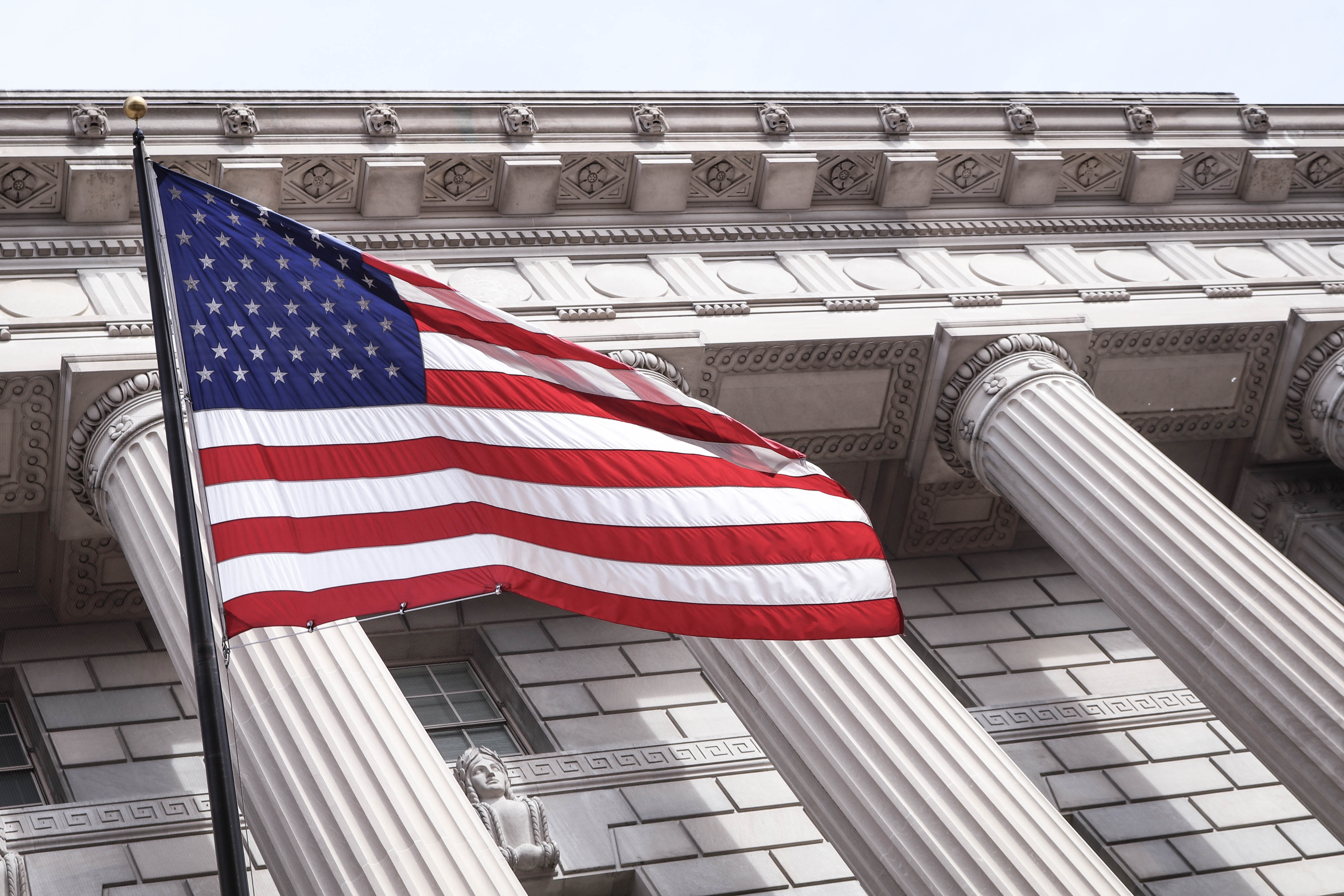 Picture of U.S. Flag in front of a courthouse.